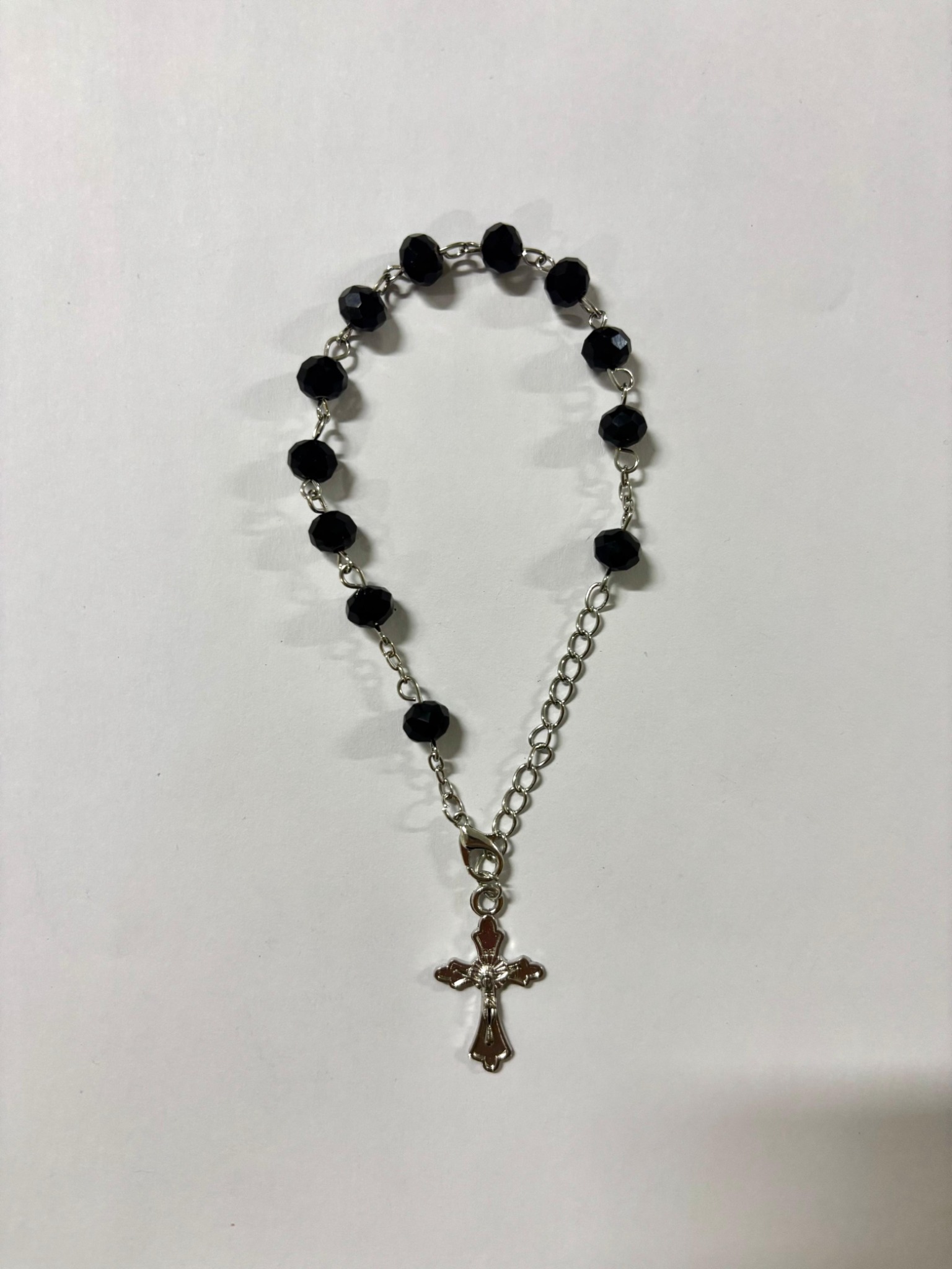 Black faceted bead rosary bracelet with silver-tone crucifix