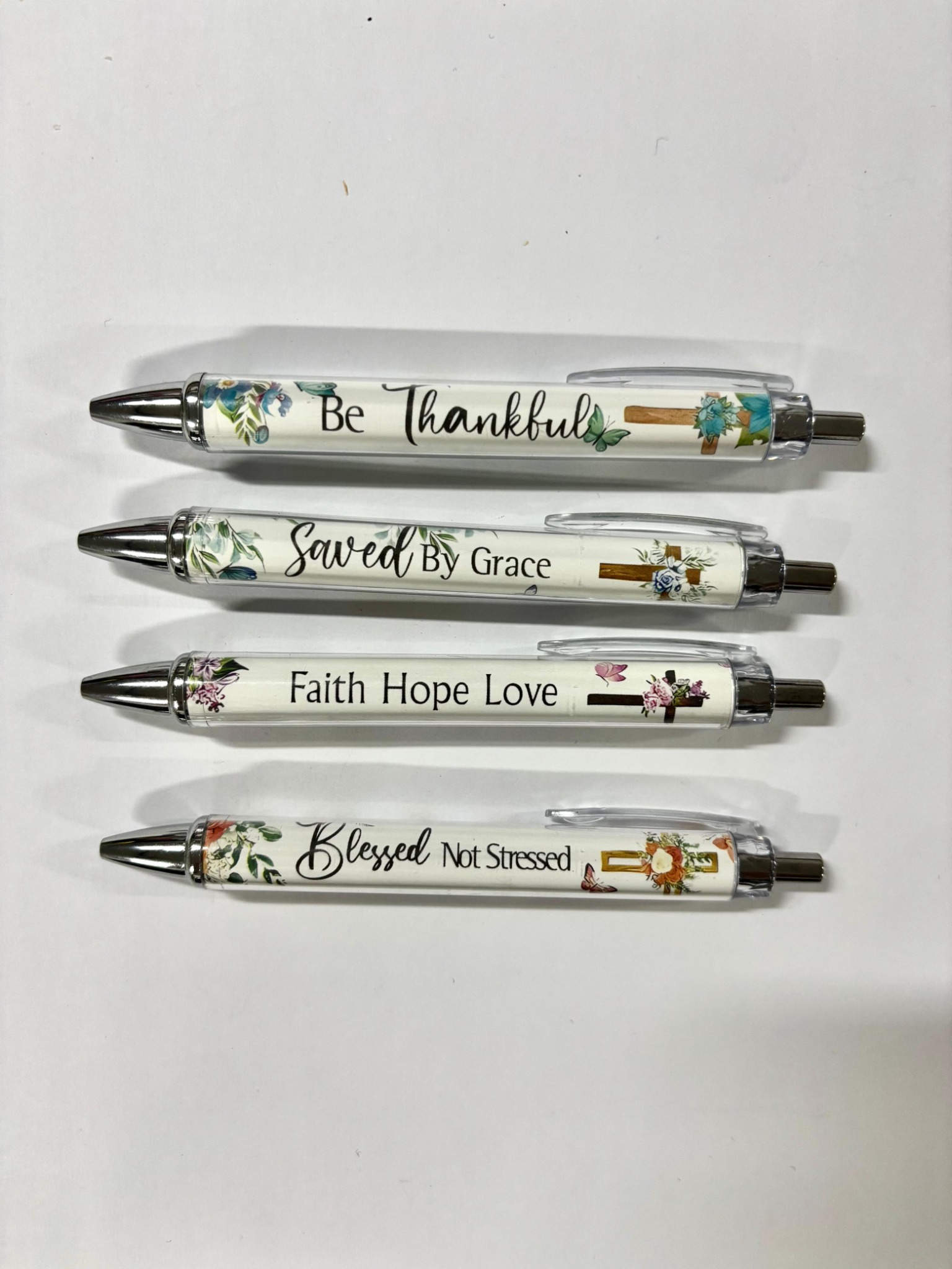 Saved By Grace Christian inspirational pen shown with floral cross design
