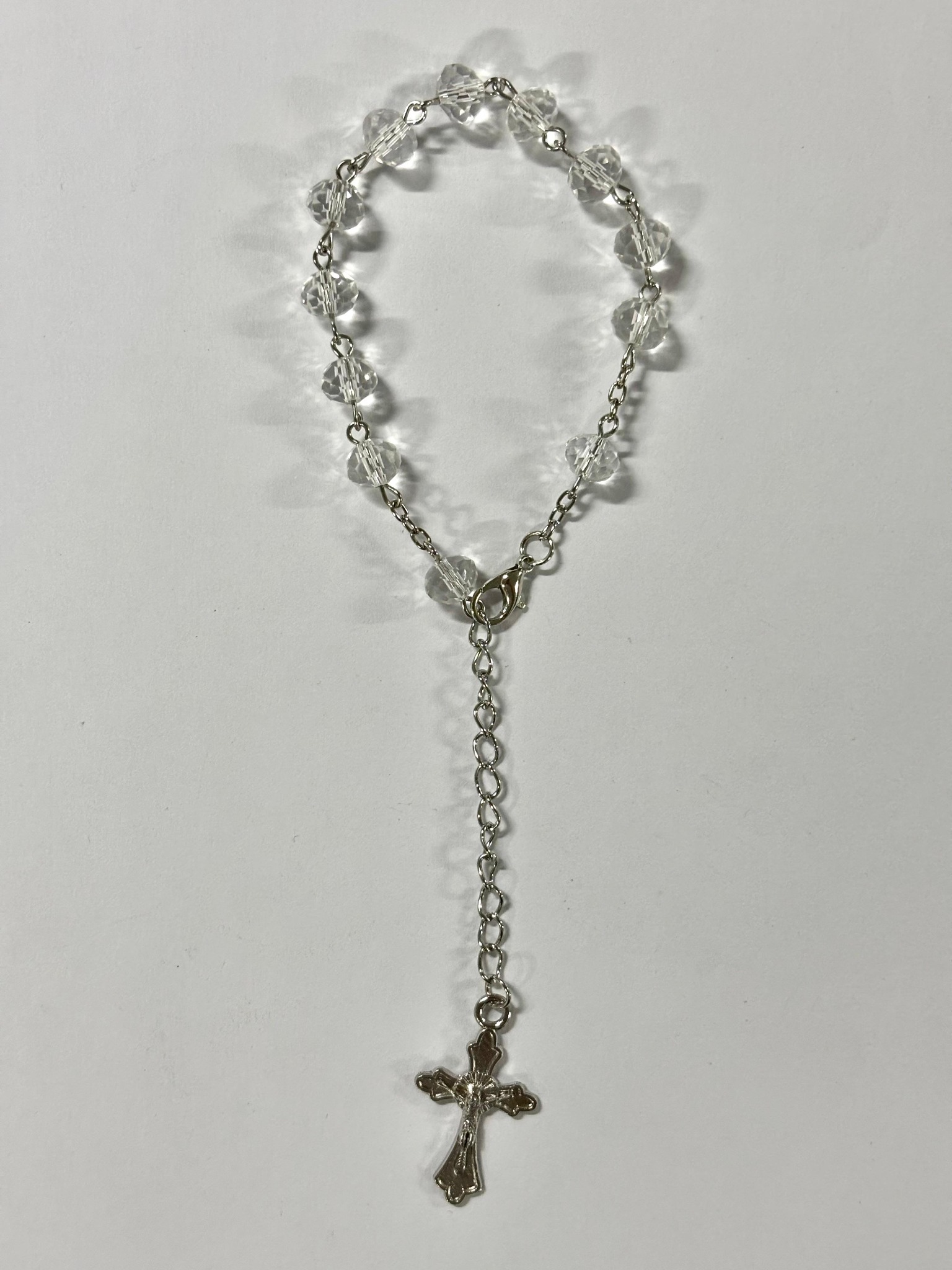Clear faceted bead rosary bracelet with silver-tone crucifix