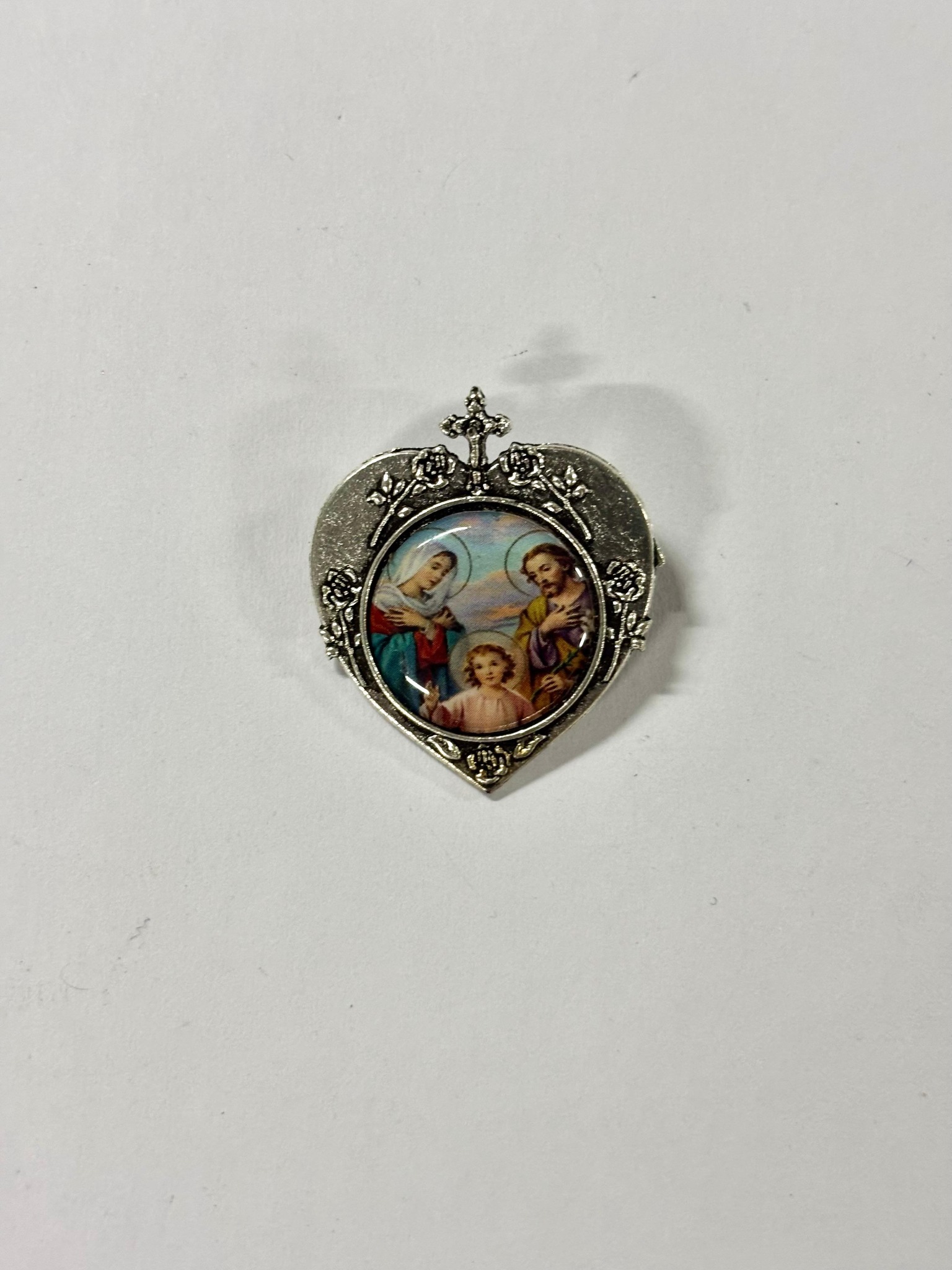 Silver-tone heart brooch featuring the Holy Family with halo imagery