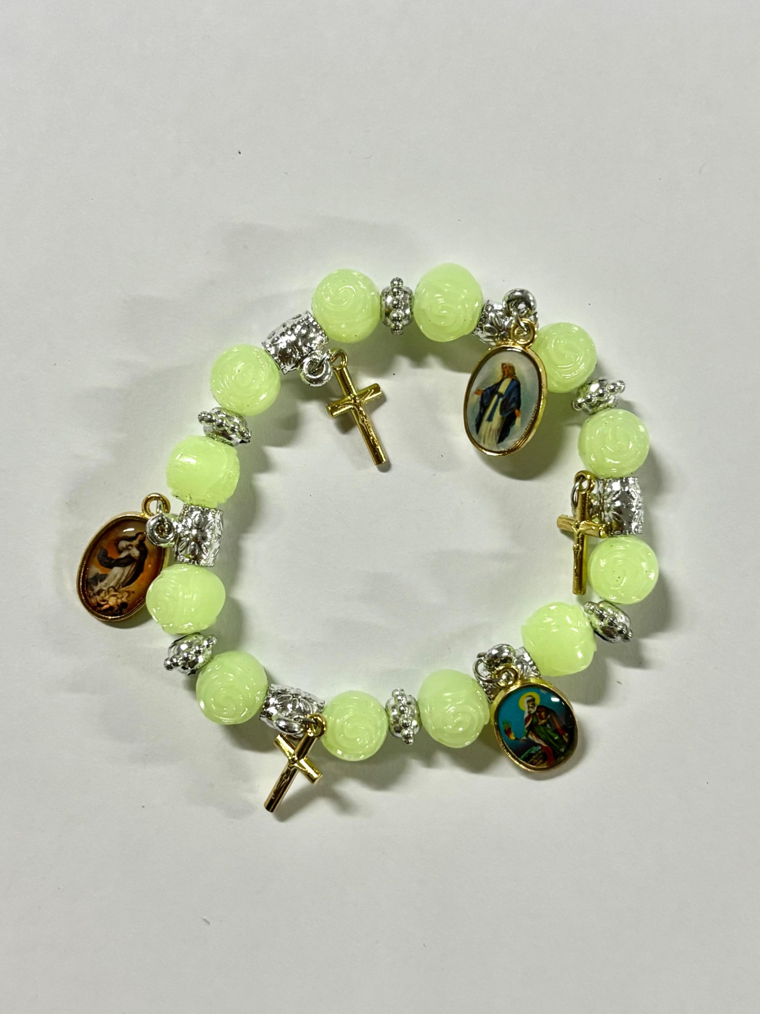 Luminous green devotional charm bracelet with Catholic medals and crosses