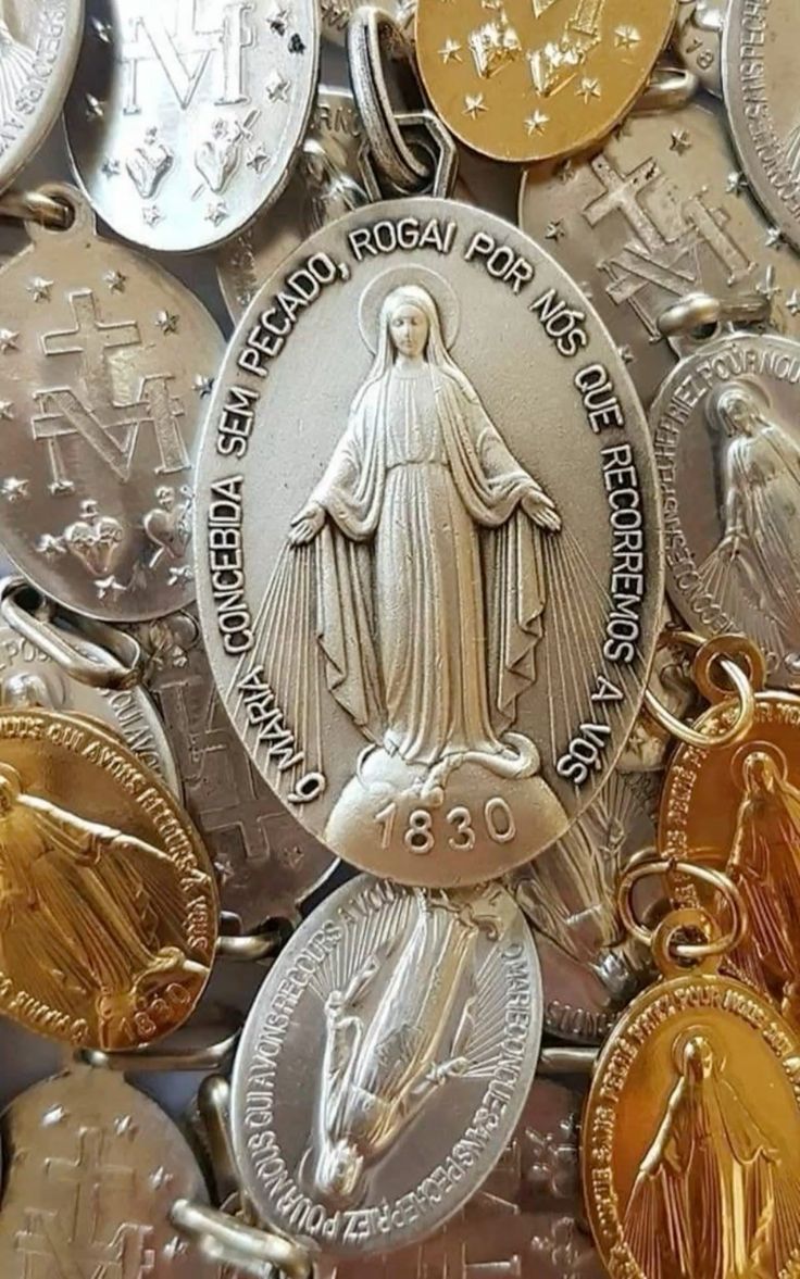 Collection of Catholic devotional medals featuring Marian imagery