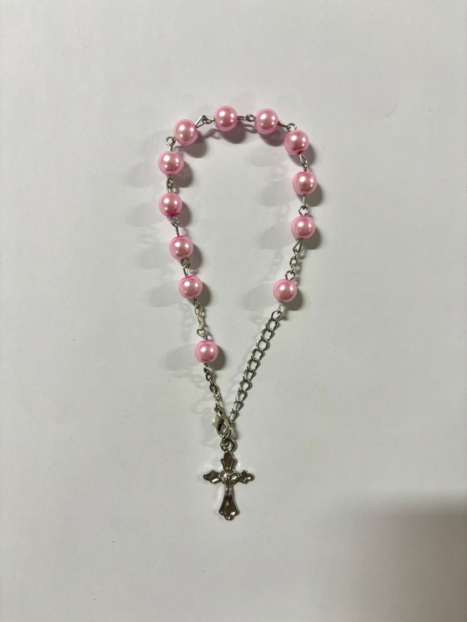 Pink pearl bead rosary bracelet with silver-tone crucifix