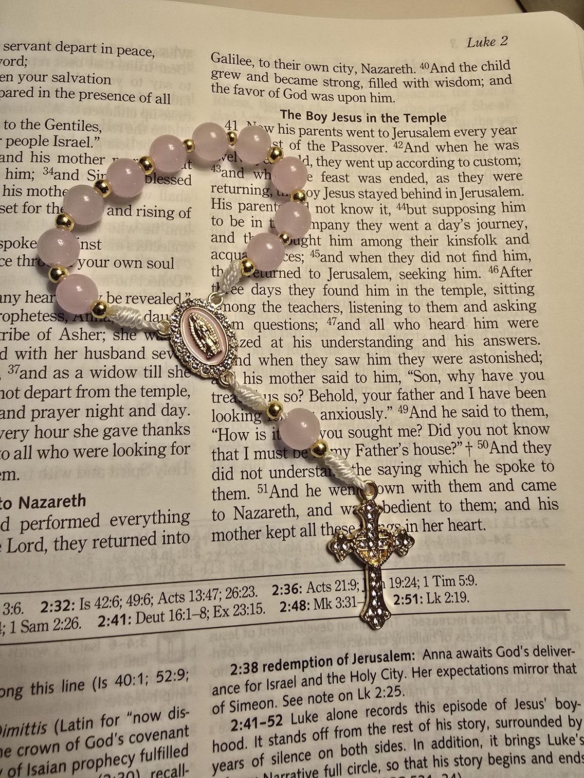 Rosary resting on an open Bible