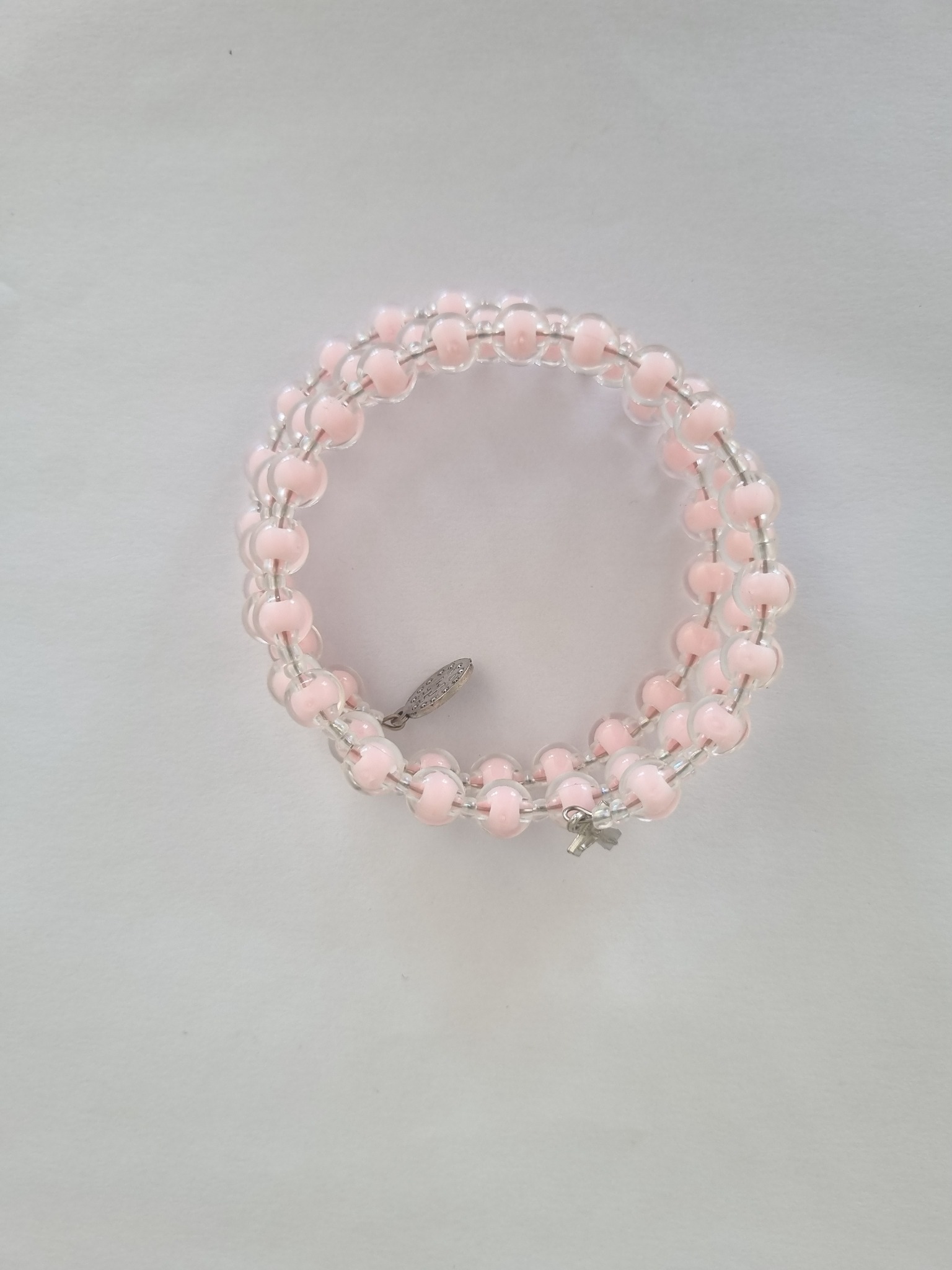 Pink Catholic rosary bracelet with devotional medal and crucifix charm