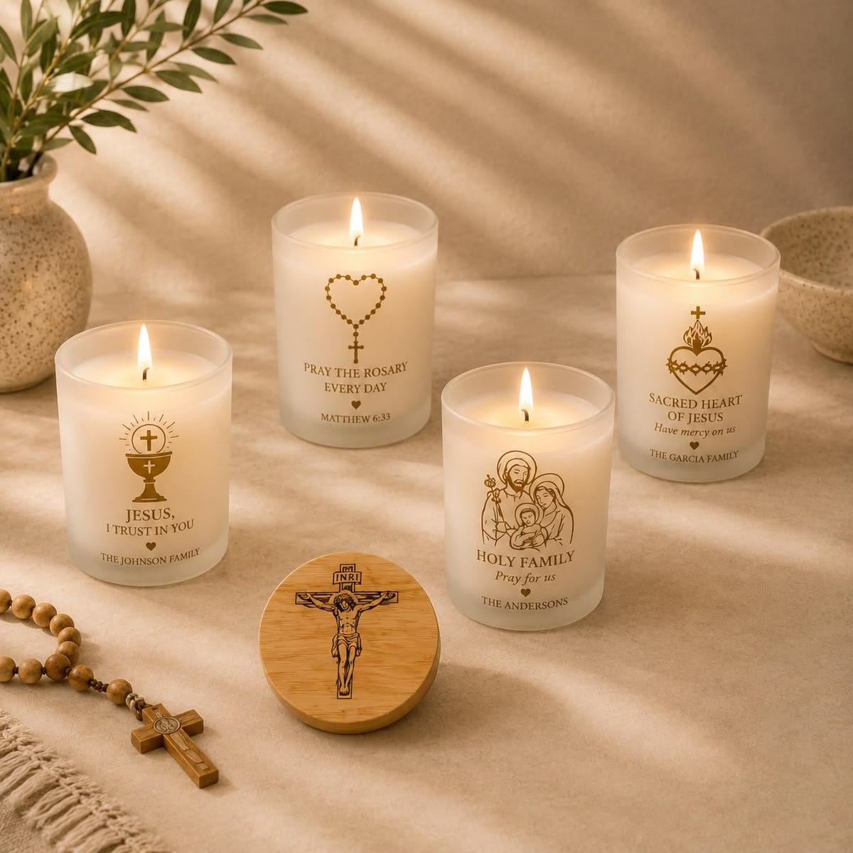 Catholic devotional candles with Christian symbols and a Rosary nearby
