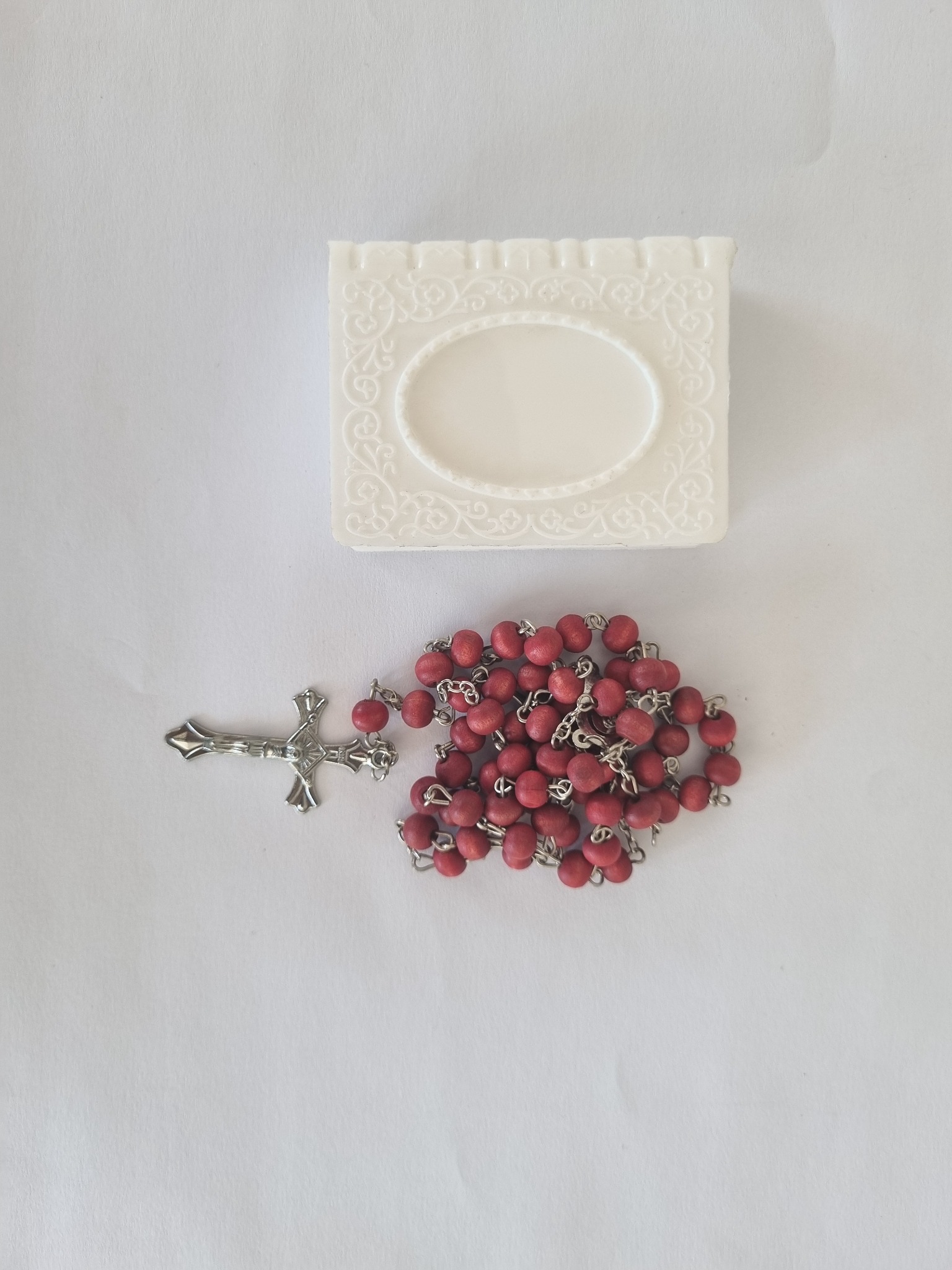 Red scented Catholic rosary with silver-tone crucifix and white presentation box